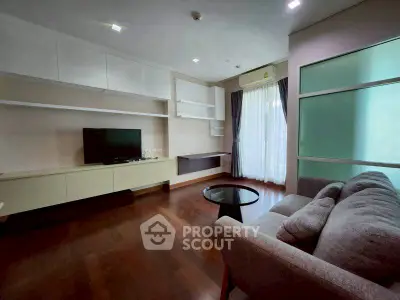 Spacious living room with modern furnishings and large window for natural light.