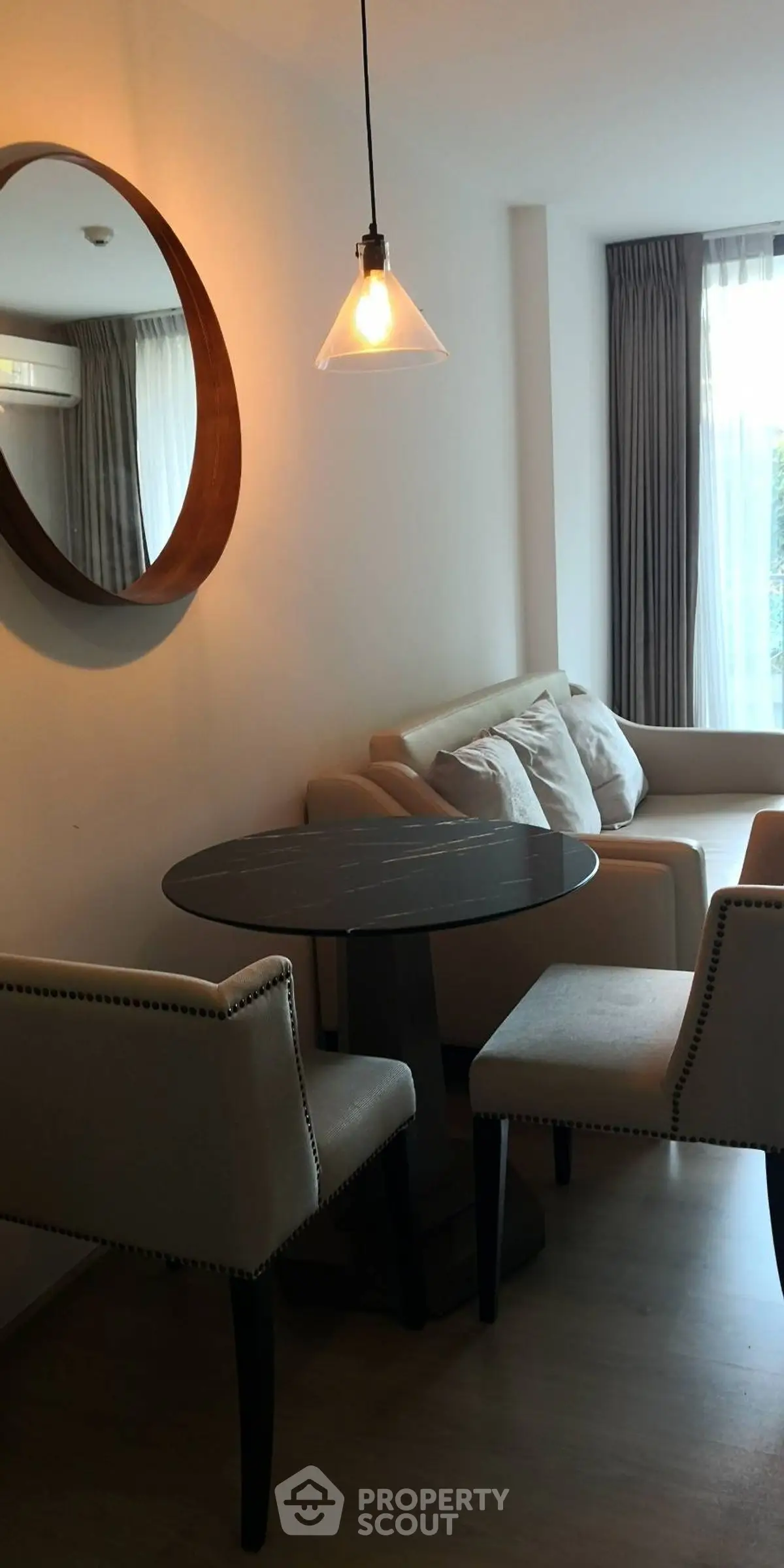 Cozy living room with modern furniture and natural light, perfect for relaxation.