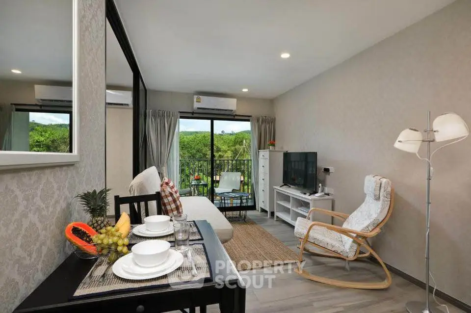 Modern living room with balcony view and stylish furniture in a cozy apartment.