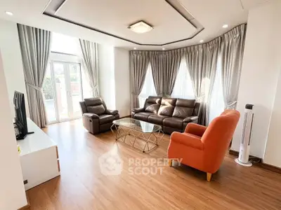 Spacious living room with modern furniture and large windows for natural light.