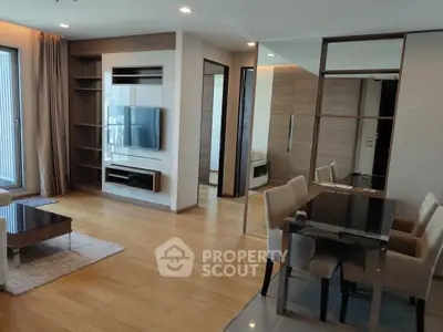 Modern living room with sleek design, hardwood floors, and built-in shelving, perfect for urban living.