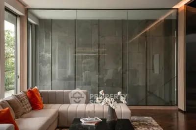 Luxurious modern living room with elegant sofa and glass wall, perfect for stylish living.