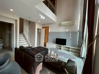 Spacious modern living room with high ceiling and stylish furniture