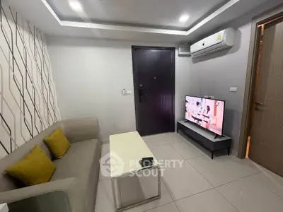Modern living room with sleek design, featuring a comfortable sofa, flat-screen TV, and stylish decor.