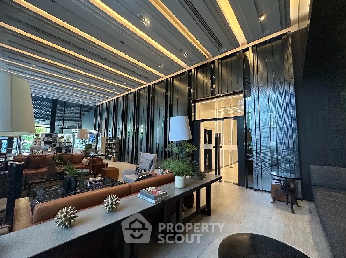 Luxurious modern lobby with elegant seating and stylish decor in a high-end building.