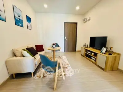 Modern living room with cozy sofa, stylish decor, and flat-screen TV in a bright apartment.