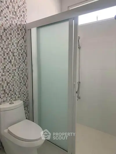 Modern bathroom with sleek shower and stylish tile design.