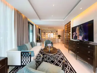 Luxurious living room with elegant decor, large TV, and stylish furniture in a modern apartment.