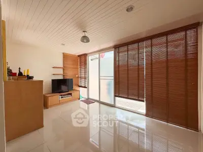 Spacious living room with modern decor and large windows for natural light.
