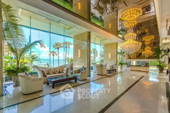 Luxurious hotel lobby with ocean view and elegant chandeliers
