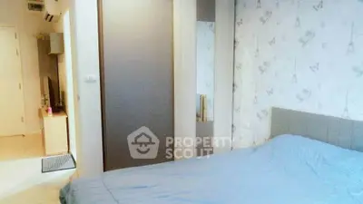 Cozy bedroom with stylish wallpaper and modern furnishings in a contemporary apartment.