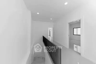 Modern minimalist hallway with sleek railing and bright lighting