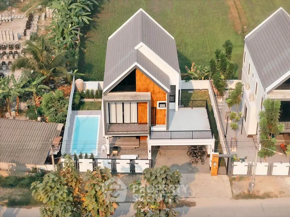 Modern two-story house with pool and lush surroundings