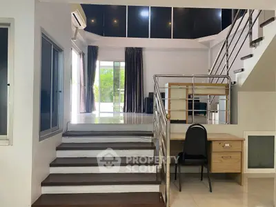 Spacious modern living room with staircase and natural light