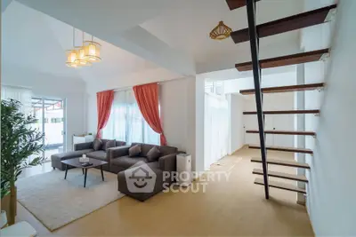 Spacious modern living room with stylish staircase and elegant decor