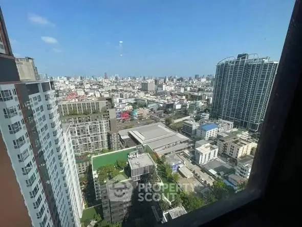 Stunning cityscape view from high-rise building window, showcasing urban skyline and modern architecture.