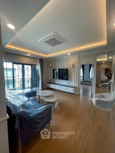 Elegant living room with modern decor and large windows leading to a balcony.