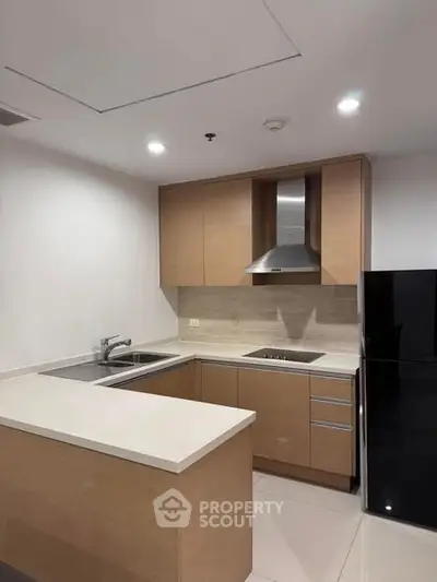 Modern kitchen with sleek cabinetry and built-in appliances in a stylish apartment.