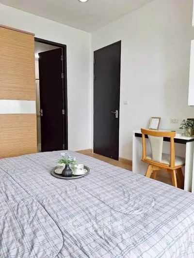 Cozy bedroom with modern decor and workspace, perfect for relaxation and productivity.