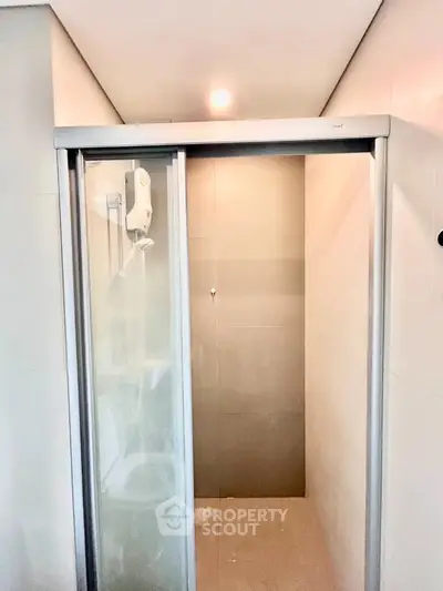 Modern bathroom with sleek shower enclosure and overhead lighting