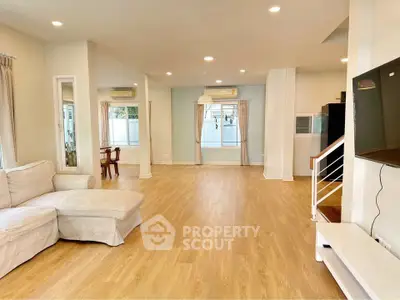 Spacious open-plan living room with modern decor and natural light