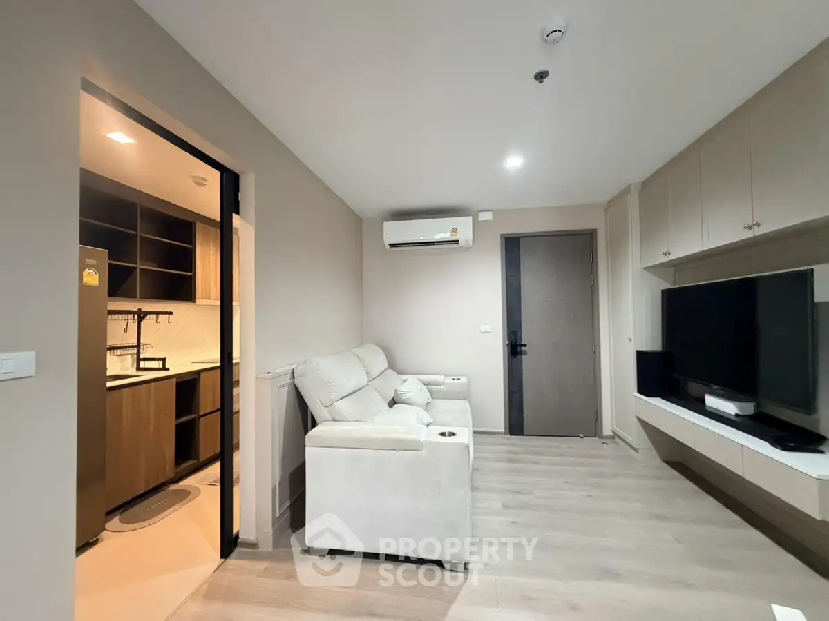 Modern living room with cozy sofa and sleek entertainment unit in stylish apartment.