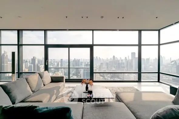 Luxurious living room with panoramic city skyline view and modern furnishings.