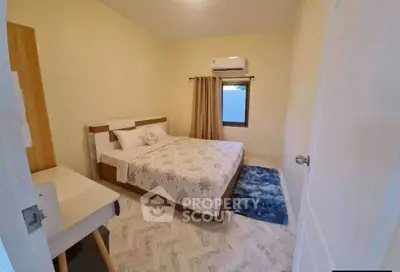 Cozy bedroom with modern furnishings and air conditioning, perfect for restful nights.