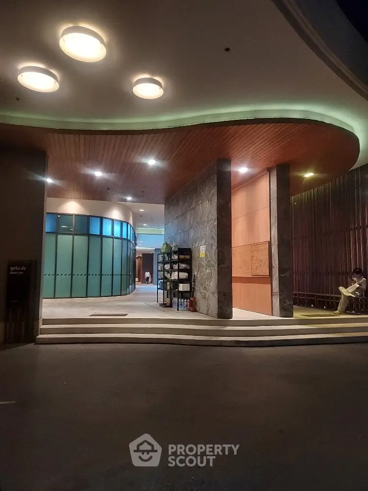 Modern building entrance with curved design and ambient lighting