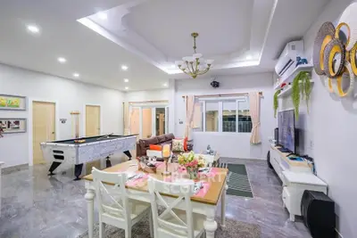 Spacious living room with modern decor, dining area, and entertainment setup, perfect for family gatherings.