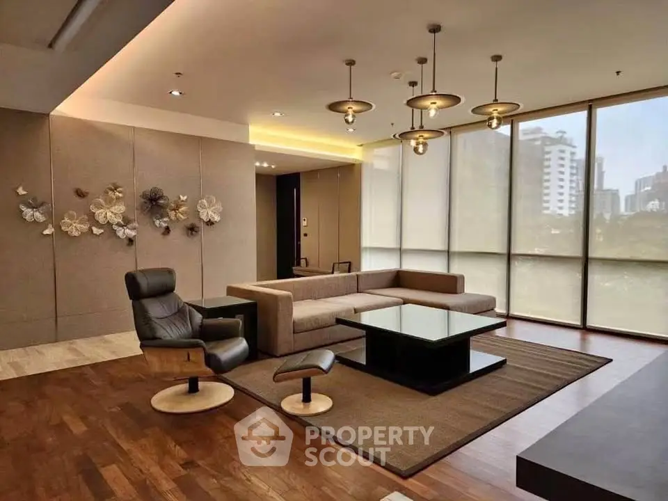 Luxurious modern living room with elegant decor and city view, featuring stylish furniture and ambient lighting.