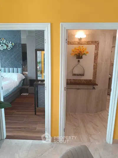 Stylish bedroom and bathroom with modern decor and vibrant yellow wall