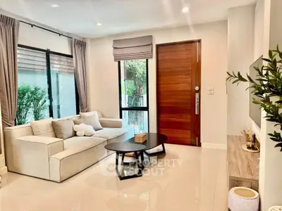 Modern living room with elegant decor and large windows for natural light.