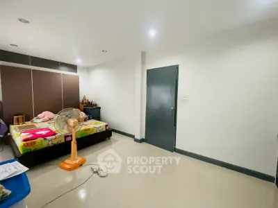 Spacious bedroom with modern decor and ample natural light