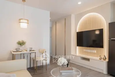 Modern living room with stylish TV setup and cozy dining area