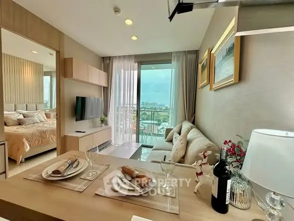 Modern open-plan living room with balcony view in stylish apartment