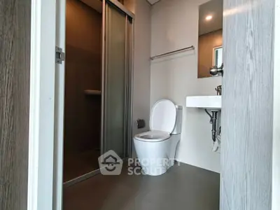 Modern bathroom with sleek design and shower enclosure in a contemporary apartment.