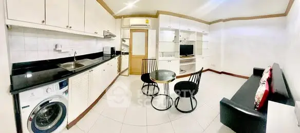 Spacious modern kitchen and living area with sleek appliances and stylish furniture.