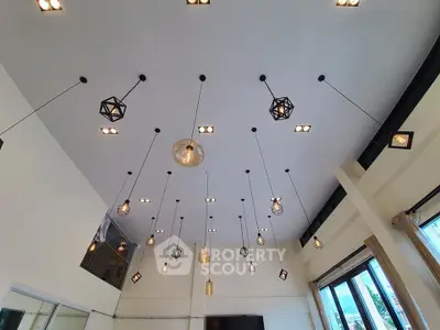 Stunning modern living room with high ceiling and elegant pendant lighting