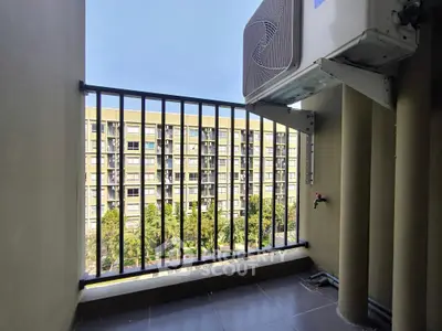 Small balcony with air conditioning unit and view of apartment building