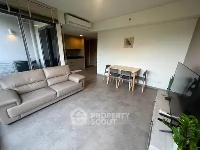 Spacious modern living room with sleek furniture and open layout, perfect for contemporary living.