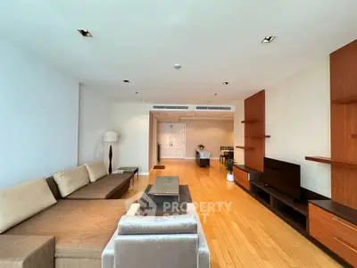 Spacious modern living room with elegant wooden flooring and stylish furniture