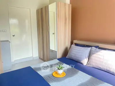 Cozy bedroom with modern wooden wardrobe and stylish decor
