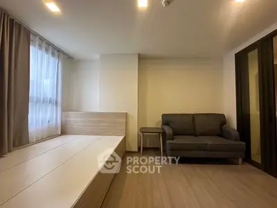 Modern minimalist living room with cozy sofa and natural light