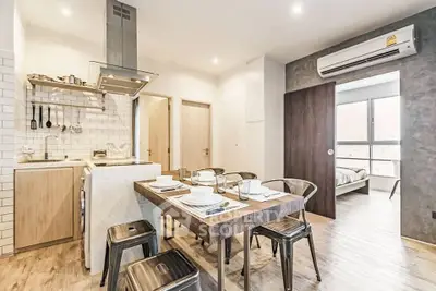 Modern open-layout kitchen and dining area with stylish decor and natural light