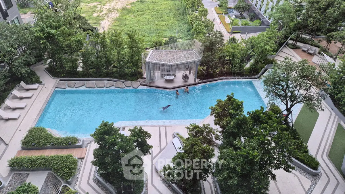 Luxurious residential pool area with lush greenery and modern design, perfect for relaxation and leisure.
