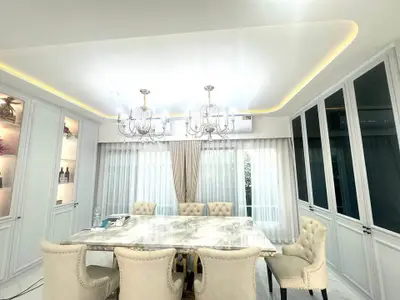 Elegant dining room with marble table and chandelier lighting