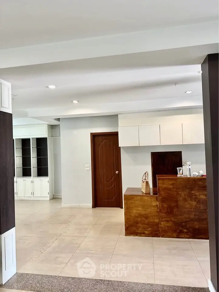 Spacious modern living area with wooden accents and built-in storage