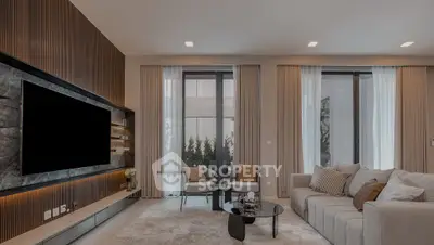 Luxurious modern living room with elegant decor and large windows offering natural light.