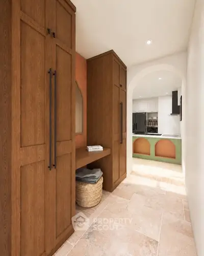 Elegant hallway with wooden cabinets leading to a modern kitchen with open layout and stylish design.